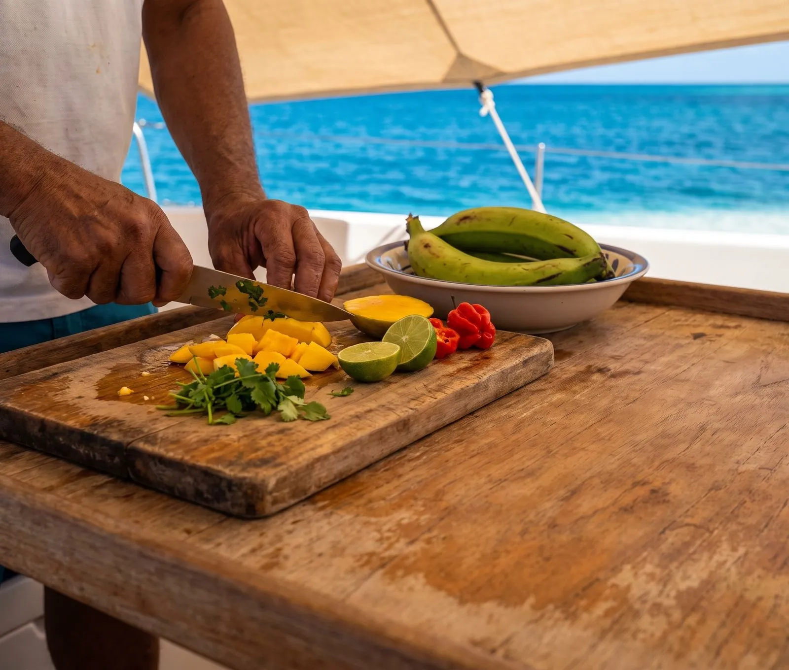 Hands chopping tropical ingredients on a wooden table