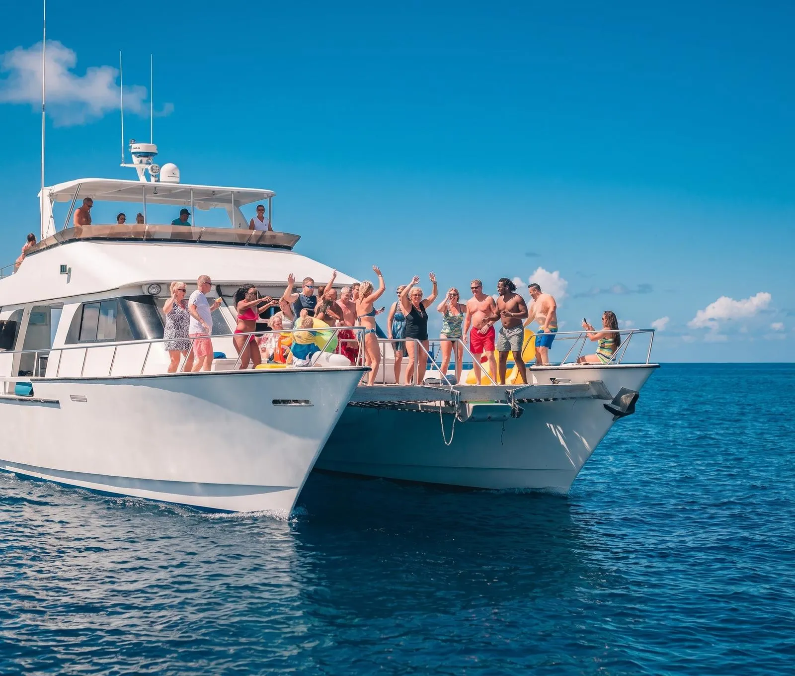 A big double-deck boat with a lively group, daylight, no bottles in focus